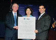 (L-R) Roy Grizzard, Assistant Secretary of Labor for Disability Employment Policy; Elaine L. Chao, Secretary of Labor; and Hector V. Barreto, Adminstrator of the Small Business Administration with the newly signed Strategic Alliance Memorandum at the Department of Labor on Thursday, Dec. 11. (DOL Photo/Neshan Naltchayan)